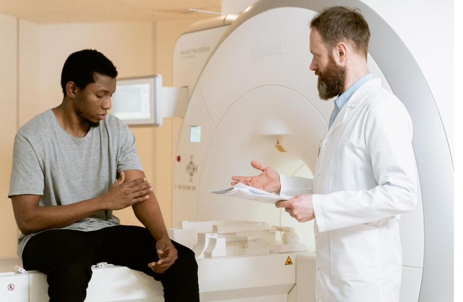 A physician explaining an imaging procedure to a patient