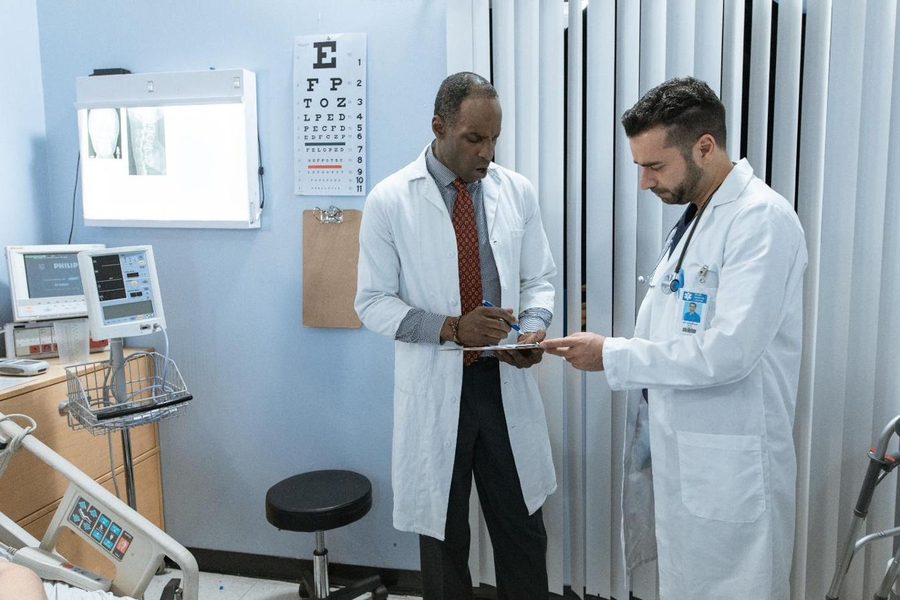 Two clinicians reviewing a case together in a consulting room