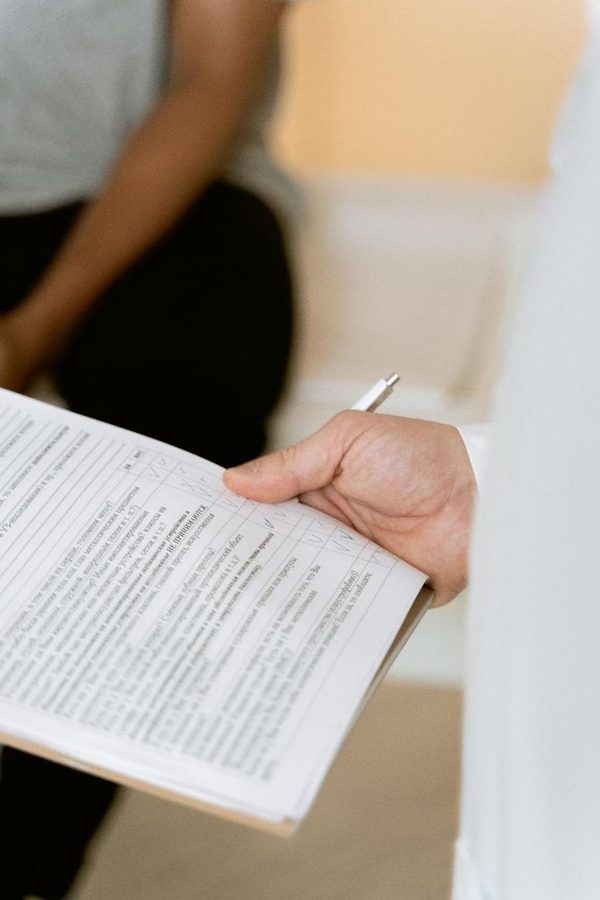 A physician reading through a patient's medical file