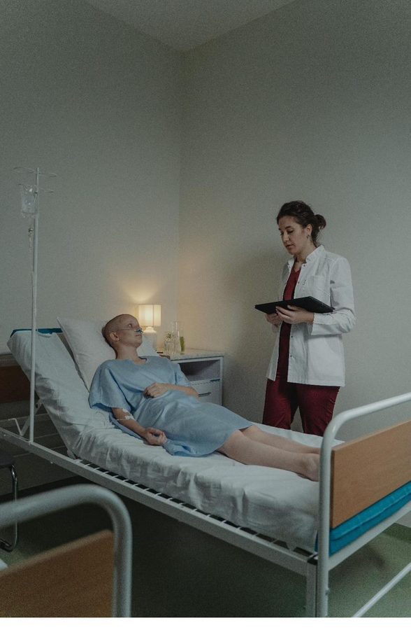 A clinician attending to a patient in a hospital room
