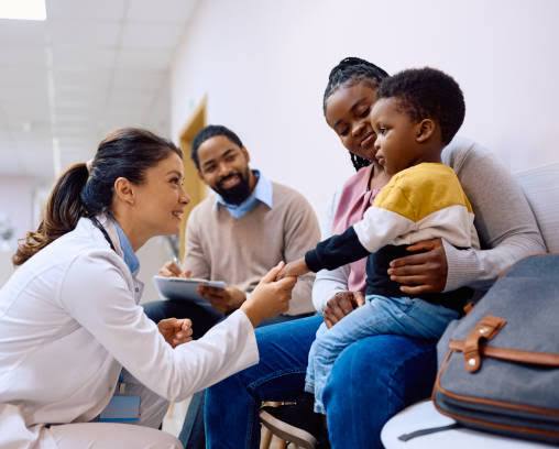 A physician speaking with a family during a consultation
